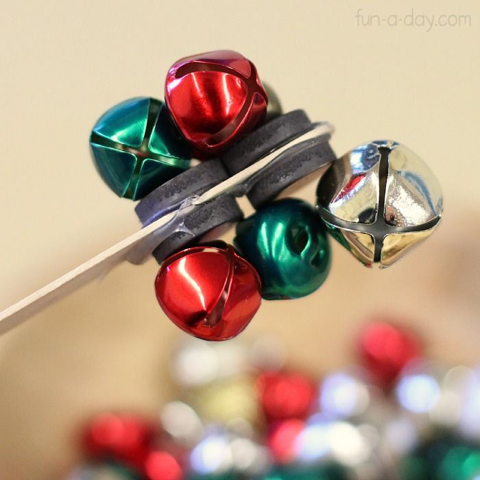 Preschool-magnet-science-with-jingle-bells-trying-to-determine-how-many-bells-the-magnets-can-pick-up